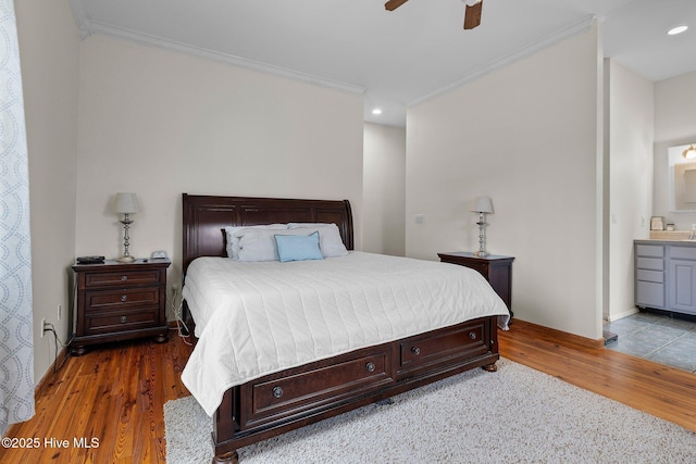 bedroom featuring recessed lighting, baseboards, wood finished floors, and crown molding