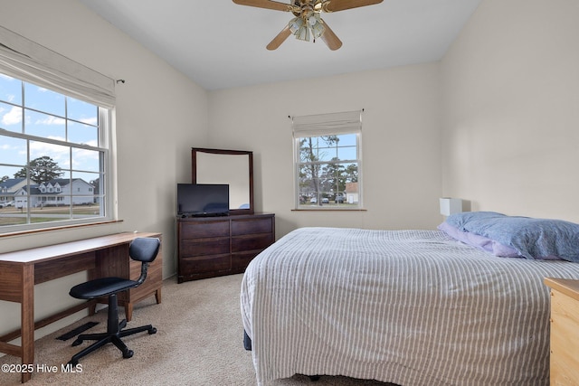 bedroom featuring a ceiling fan and light carpet