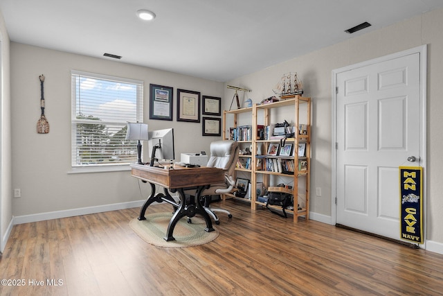 home office featuring visible vents, wood finished floors, and baseboards