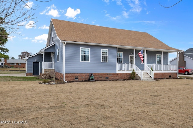 view of front of property featuring a front yard, crawl space, a shingled roof, and covered porch