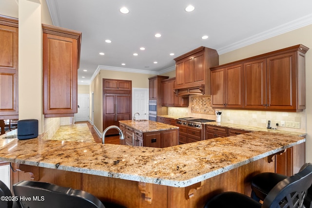 8904 Sound View Ct, Emerald Isle, NC 28594 - kitchen with a peninsula, custom exhaust hood, recessed lighting, and light stone counters
