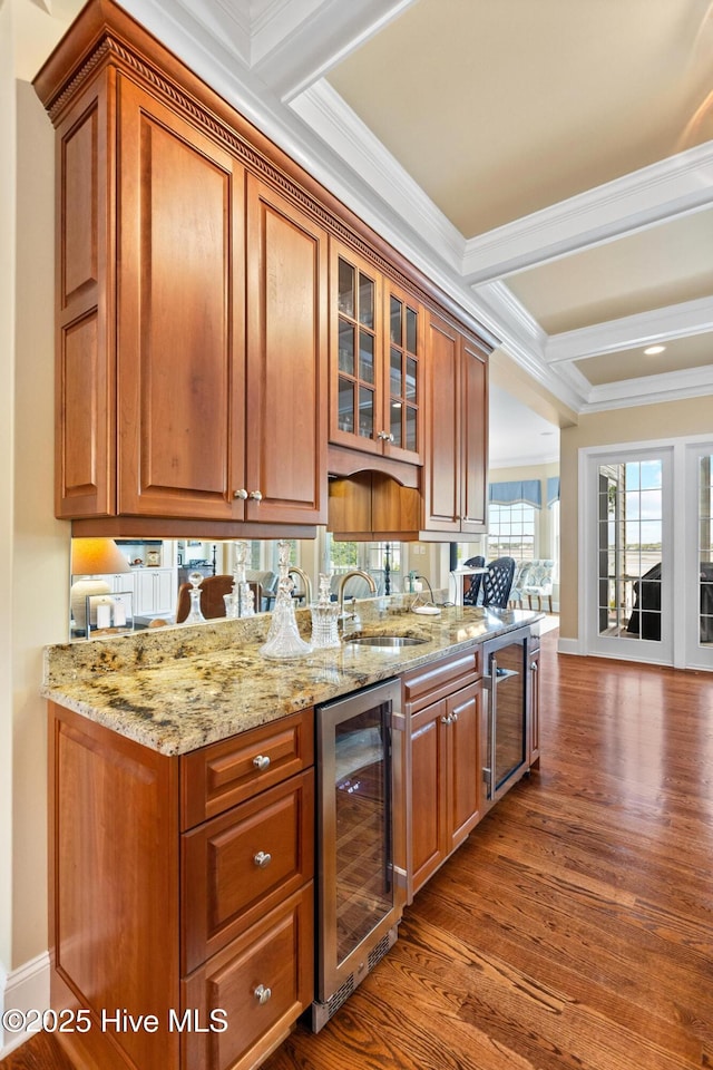 8904 Sound View Ct, Emerald Isle, NC 28594 - kitchen featuring ornamental molding, beverage cooler, light stone counters, and dark wood-type flooring