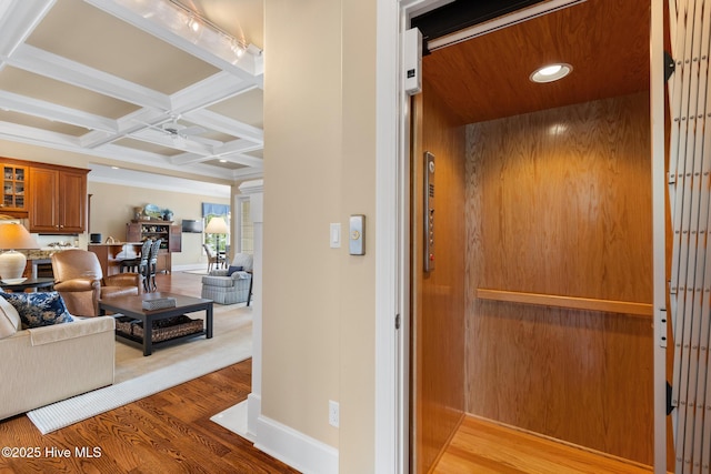 8904 Sound View Ct, Emerald Isle, NC 28594 - corridor featuring coffered ceiling, beamed ceiling, elevator, baseboards, and light wood-style flooring