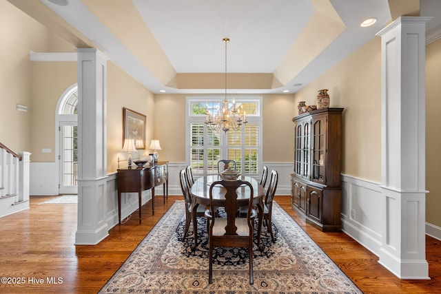 8904 Sound View Ct, Emerald Isle, NC 28594 - dining area featuring wood finished floors, a chandelier, stairway, and a tray ceiling