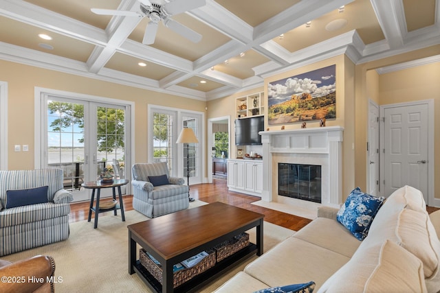 8904 Sound View Ct, Emerald Isle, NC 28594 - living area featuring coffered ceiling, a ceiling fan, a premium fireplace, beam ceiling, and crown molding