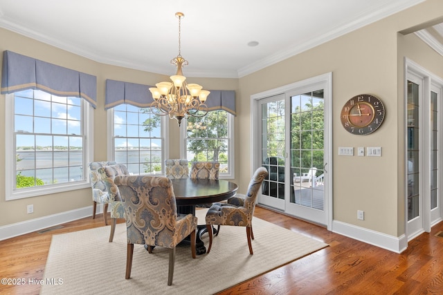 8904 Sound View Ct, Emerald Isle, NC 28594 - dining room featuring visible vents, baseboards, ornamental molding, and an inviting chandelier