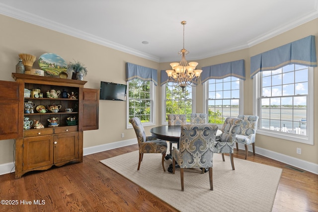 8904 Sound View Ct, Emerald Isle, NC 28594 - dining room featuring plenty of natural light, baseboards, visible vents, and a chandelier