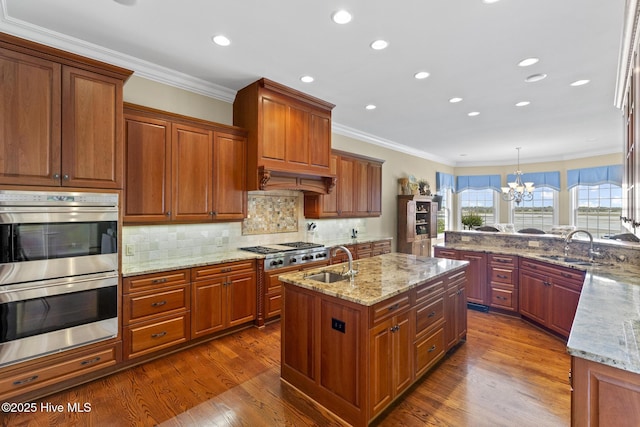 8904 Sound View Ct, Emerald Isle, NC 28594 - kitchen with ornamental molding, appliances with stainless steel finishes, a sink, and dark wood-style floors
