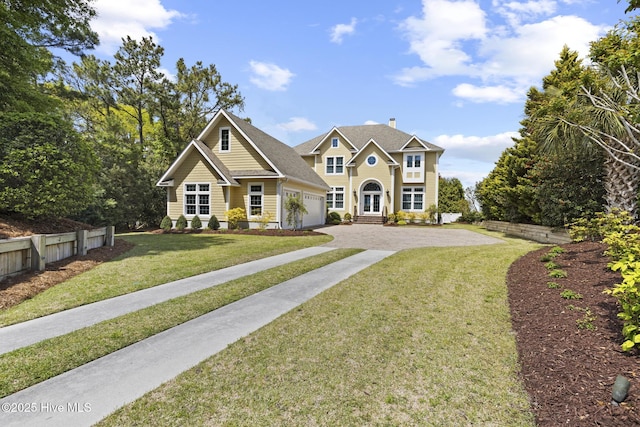 8904 Sound View Ct, Emerald Isle, NC 28594 - view of front facade featuring driveway, french doors, a front yard, and a garage