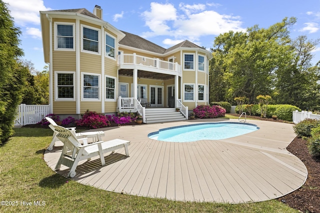 8904 Sound View Ct, Emerald Isle, NC 28594 - rear view of property with a balcony, a chimney, a deck, fence, and a fenced in pool