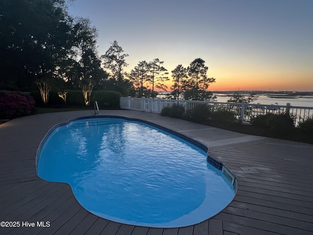 8904 Sound View Ct, Emerald Isle, NC 28594 - pool at dusk with fence, a fenced in pool, and a water view