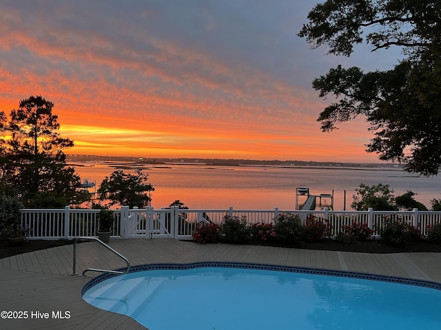 8904 Sound View Ct, Emerald Isle, NC 28594 - pool at dusk featuring a fenced in pool and a deck with water view