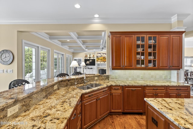 8904 Sound View Ct, Emerald Isle, NC 28594 - kitchen with light stone countertops, light wood finished floors, a sink, and coffered ceiling
