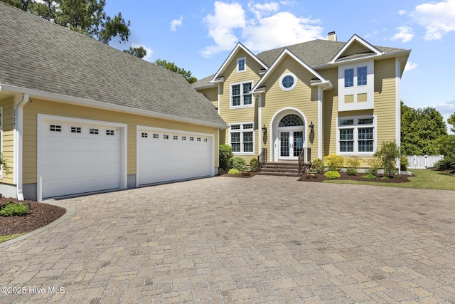 8904 Sound View Ct, Emerald Isle, NC 28594 - view of front of house featuring a chimney, an attached garage, decorative driveway, and a shingled roof