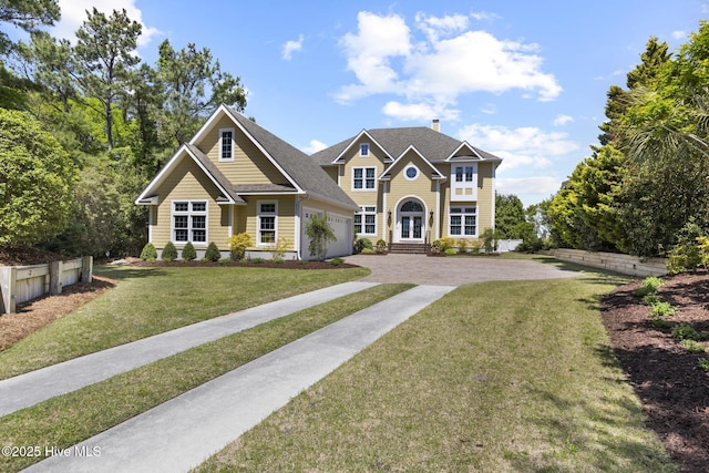 8904 Sound View Ct, Emerald Isle, NC 28594 - view of front of house featuring a chimney, driveway, french doors, a front yard, and a garage