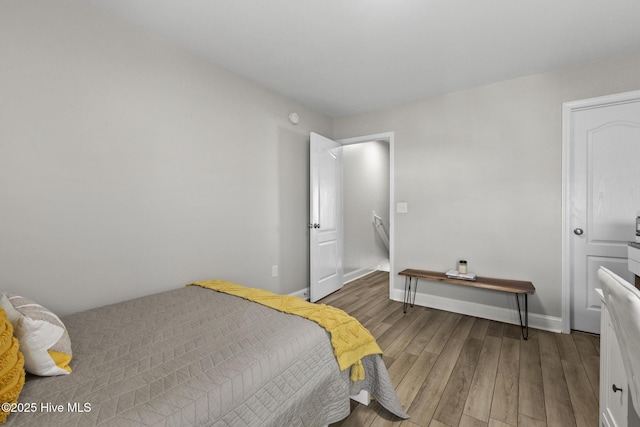 bedroom with wood finished floors and baseboards