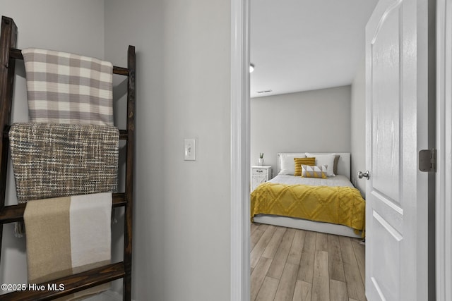 bedroom with wood finished floors and visible vents