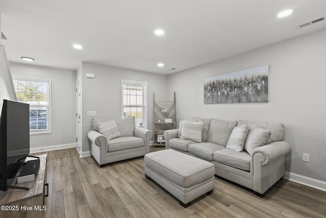 living area featuring recessed lighting, a healthy amount of sunlight, and wood finished floors