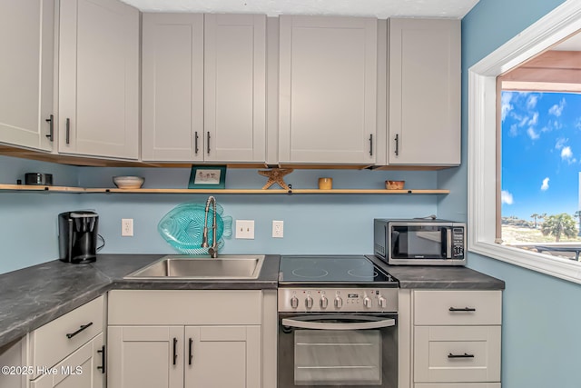 kitchen with a sink, white cabinetry, stainless steel appliances, and open shelves