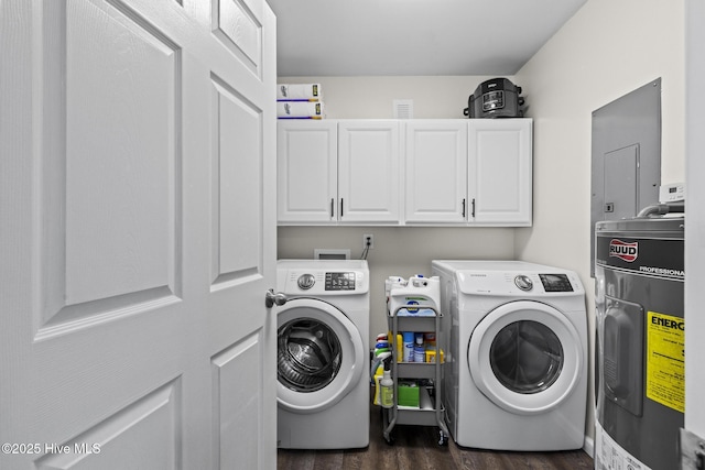 washroom featuring independent washer and dryer, dark wood-style floors, cabinet space, and water heater