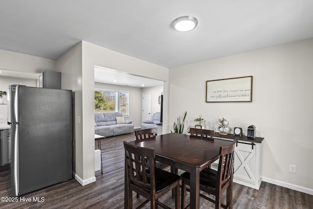 dining room featuring dark wood-style floors and baseboards