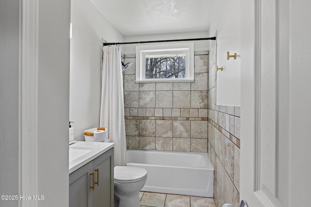 full bath featuring tile patterned floors, shower / bath combo with shower curtain, toilet, and vanity