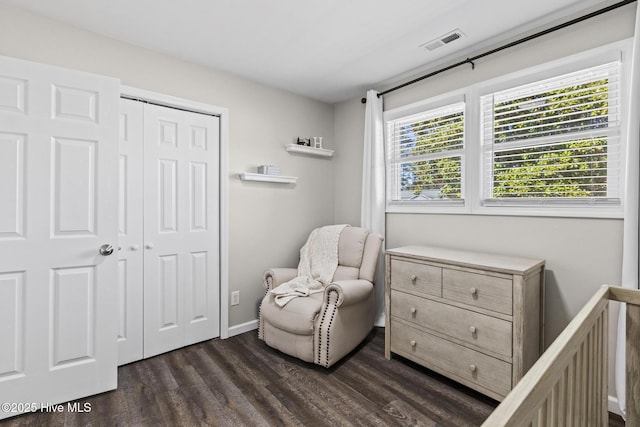 bedroom with a closet, baseboards, visible vents, and dark wood-style flooring