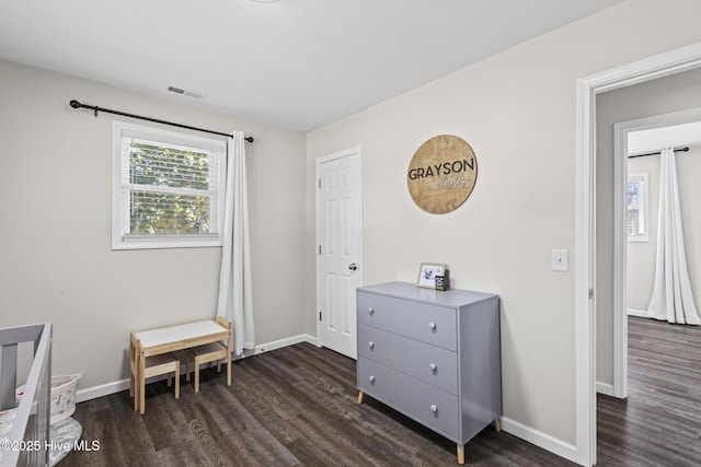 bedroom featuring dark wood-type flooring, baseboards, and visible vents