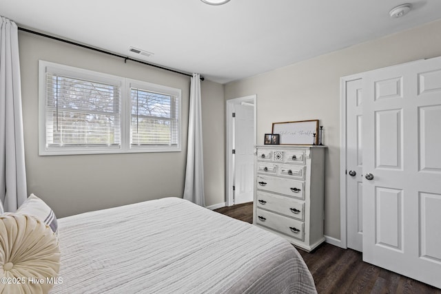 bedroom featuring dark wood-type flooring, baseboards, and visible vents