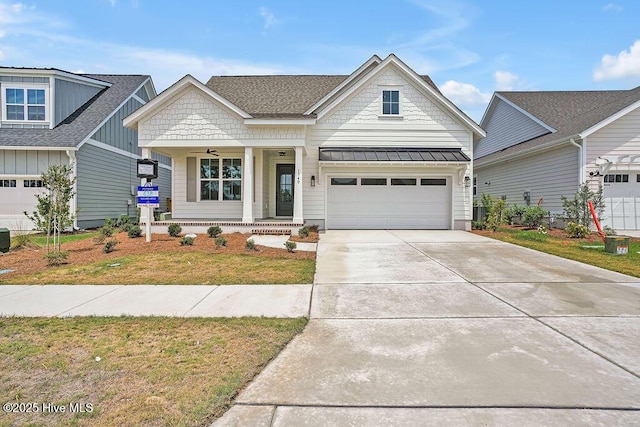 1340 Trisail Ter, Wilmington, NC 28412 - view of front of home with a porch, a garage, concrete driveway, a standing seam roof, and board and batten siding