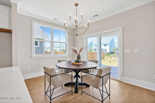1340 Trisail Ter, Wilmington, NC 28412 - dining room featuring a chandelier, baseboards, light wood-type flooring, and ornamental molding