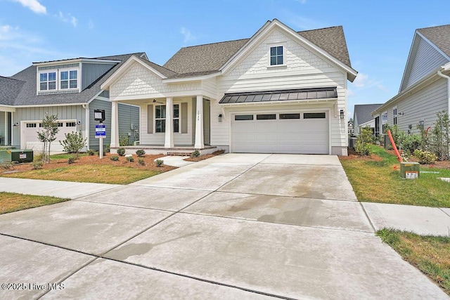1340 Trisail Ter, Wilmington, NC 28412 - view of front of property with covered porch, a standing seam roof, concrete driveway, an attached garage, and metal roof