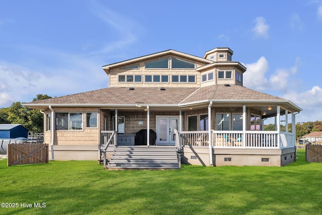 view of front facade with crawl space, covered porch, a front lawn, and fence