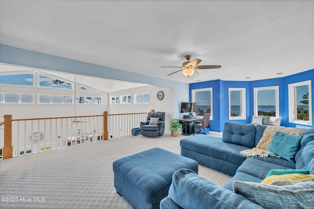 living room with vaulted ceiling, carpet, and ceiling fan