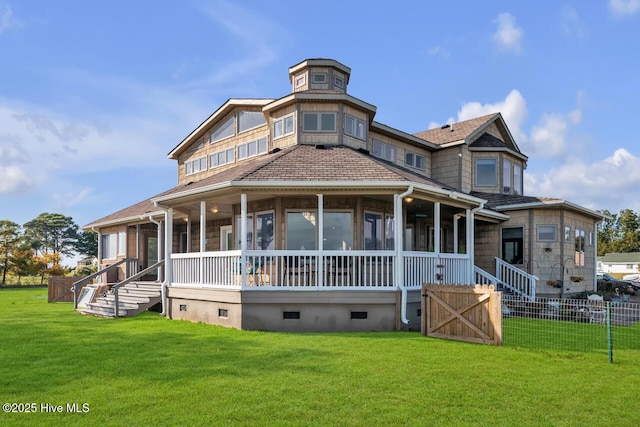 view of front of property featuring crawl space, fence, a front yard, and a sunroom