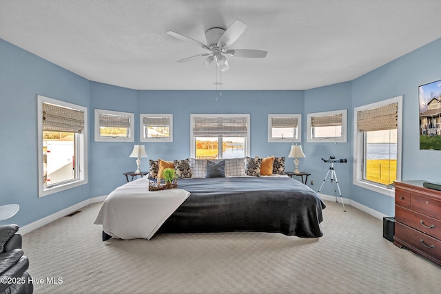 carpeted bedroom featuring visible vents, ceiling fan, and baseboards