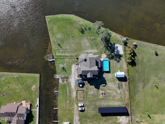 dock area with a yard, a water view, and fence