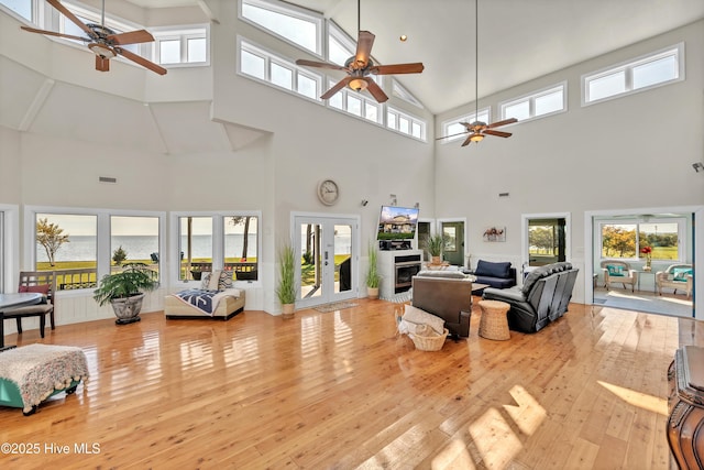 living area featuring hardwood / wood-style flooring, visible vents, and ceiling fan