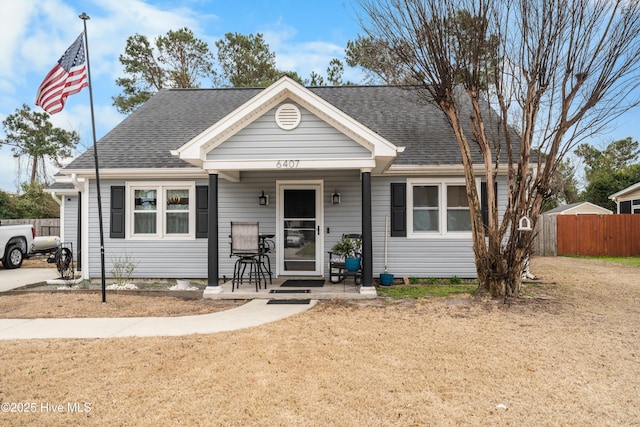 bungalow-style house featuring fence and a shingled roof