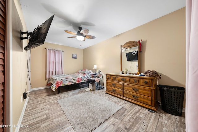 bedroom featuring a ceiling fan, wood finished floors, and baseboards