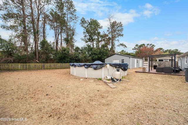 view of yard featuring a pergola, a jacuzzi, fence, and a fenced in pool