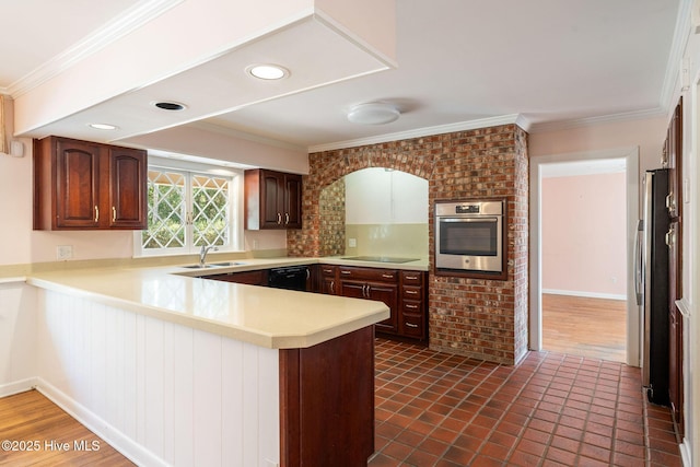 kitchen with ornamental molding, a peninsula, black appliances, and a sink