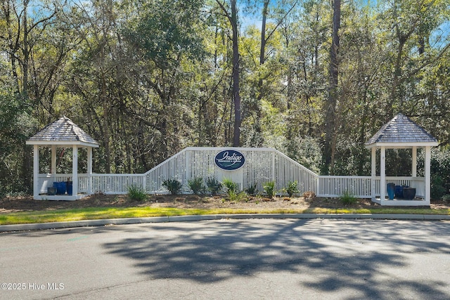 exterior space featuring curbs and a view of trees