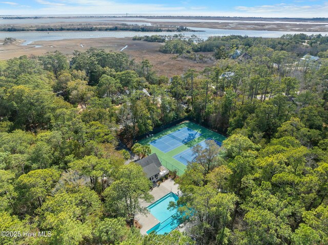 bird's eye view featuring a forest view and a water view