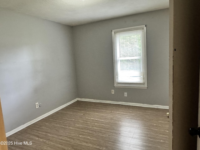 2604 Robeson St, Wilmington, NC 28405 - spare room with wood finished floors and baseboards
