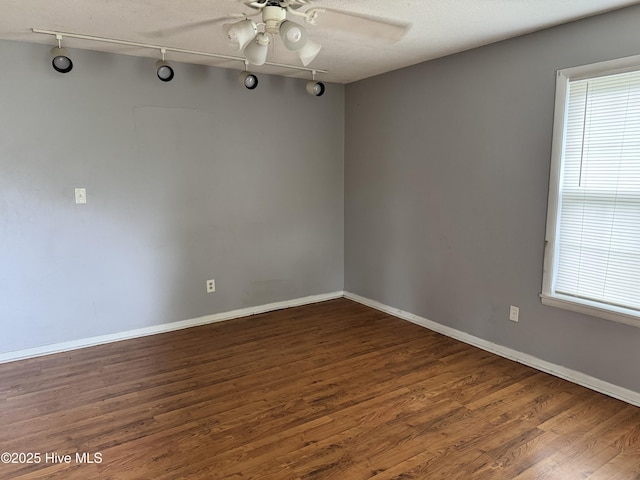 2604 Robeson St, Wilmington, NC 28405 - empty room with wood finished floors, a ceiling fan, baseboards, rail lighting, and a textured ceiling