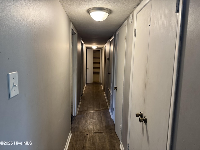 2604 Robeson St, Wilmington, NC 28405 - hall with dark wood-style flooring, a textured ceiling, and baseboards