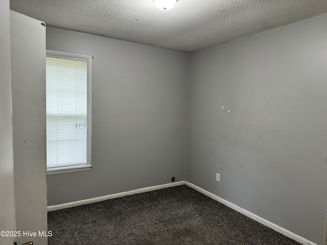 2604 Robeson St, Wilmington, NC 28405 - unfurnished room with dark carpet, a textured ceiling, and baseboards