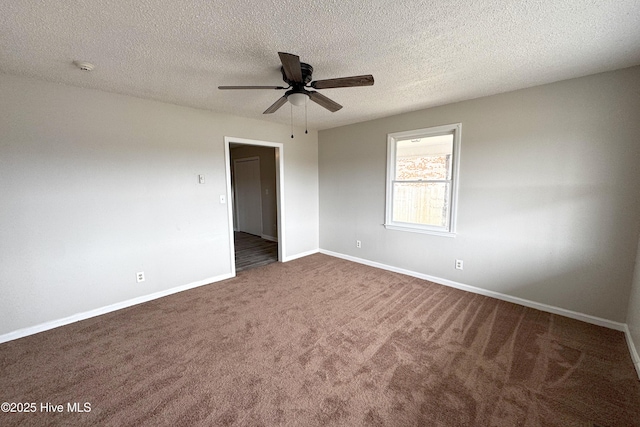 unfurnished room with a textured ceiling, baseboards, a ceiling fan, and dark colored carpet