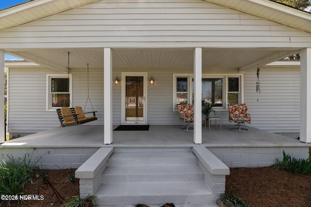 view of exterior entry with covered porch